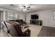Carpet and wood floors accent this living room, featuring a ceiling fan, fireplace and leather furniture at 3730 S Chaparral Rd, Apache Junction, AZ 85119