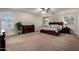 Spacious primary bedroom featuring a large bed, dark wood furniture, and natural light at 3730 S Chaparral Rd, Apache Junction, AZ 85119