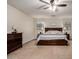 Spacious main bedroom featuring a ceiling fan and a large bed with nightstands and dressers at 3730 S Chaparral Rd, Apache Junction, AZ 85119