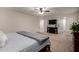 View of main bedroom with large flat screen tv and doorway to en suite bathroom at 3730 S Chaparral Rd, Apache Junction, AZ 85119