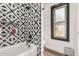 Modern bathroom features a shower with decorative tiling, a tub, and a window for natural light at 3756 E Clovis Ave, Mesa, AZ 85206