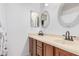Bright bathroom featuring a double vanity, light countertops, dark wood cabinets and decorative mirrors at 3756 E Clovis Ave, Mesa, AZ 85206