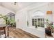 Inviting foyer featuring a front door, light hardwood floors, and natural lighting at 3756 E Clovis Ave, Mesa, AZ 85206