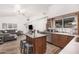 Open-concept kitchen with island seating flows into the adjacent living area at 3756 E Clovis Ave, Mesa, AZ 85206