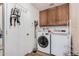 Functional laundry room with washer, dryer, cabinets, and ample space for laundry tasks at 3756 E Clovis Ave, Mesa, AZ 85206