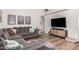 Comfortable living room featuring a gray sofa and light hardwood floors at 3756 E Clovis Ave, Mesa, AZ 85206