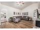 Spacious living room with light hardwood floors and modern ceiling fan at 3756 E Clovis Ave, Mesa, AZ 85206