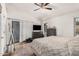 Main bedroom featuring a ceiling fan, sliding glass door, and wood-look floors at 3756 E Clovis Ave, Mesa, AZ 85206