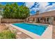Inviting pool surrounded by a spacious patio, landscaping, and comfortable seating for relaxation at 3756 E Clovis Ave, Mesa, AZ 85206