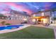 Backyard view with a pool, covered patio, and an outdoor dining area at 4106 E Muirwood Dr, Phoenix, AZ 85048