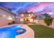 Lush backyard featuring a pool, covered patio, and an outdoor living space at 4106 E Muirwood Dr, Phoenix, AZ 85048