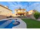 Lush backyard featuring a pool, patio with lights, and outdoor seating, perfect for relaxation and entertaining guests at 4106 E Muirwood Dr, Phoenix, AZ 85048