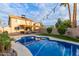 Sparkling pool surrounded by lush landscaping and a cozy covered patio, creating a perfect outdoor oasis at 4106 E Muirwood Dr, Phoenix, AZ 85048