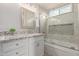 Updated bathroom with a stylish vanity, granite countertop, and a beautifully tiled shower/tub combination at 4106 E Muirwood Dr, Phoenix, AZ 85048
