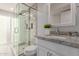 Elegant bathroom featuring a glass shower with rainfall showerhead and a granite vanity with a decorative mirror at 4106 E Muirwood Dr, Phoenix, AZ 85048