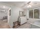 Cozy bedroom with a white dresser, decorative mirror, ceiling fan, and a well-lit window with curtains at 4106 E Muirwood Dr, Phoenix, AZ 85048