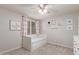 Bright bedroom with a daybed, charming decor, ceiling fan, and a window with stylish pink curtains at 4106 E Muirwood Dr, Phoenix, AZ 85048