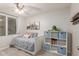 Charming bedroom with storage bed, blue storage cubes, and a ceiling fan for added comfort and style at 4106 E Muirwood Dr, Phoenix, AZ 85048