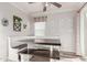Cozy dining area with built-in bench seating, a table, and natural light at 4106 E Muirwood Dr, Phoenix, AZ 85048