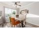 Sunlit dining area with a rustic table, stylish chairs, and a charming decorative mirror at 4106 E Muirwood Dr, Phoenix, AZ 85048