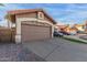 Garage exterior with stone accents, a spacious driveway, and neat landscaping at 4106 E Muirwood Dr, Phoenix, AZ 85048
