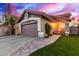 Charming home exterior with a well-maintained garage, brick accents, and landscaped front yard at 4106 E Muirwood Dr, Phoenix, AZ 85048