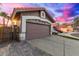 Garage exterior showcasing stone accents, a spacious driveway, and well-maintained landscaping at 4106 E Muirwood Dr, Phoenix, AZ 85048