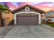 Garage with exterior stone accents and a spacious driveway, offering ample parking at 4106 E Muirwood Dr, Phoenix, AZ 85048