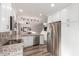 Bright open kitchen featuring granite countertops, stainless steel appliances, and white cabinets at 4106 E Muirwood Dr, Phoenix, AZ 85048