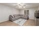 Comfortable living room featuring a large sectional sofa, stylish rug, and a ceiling fan for relaxation at 4106 E Muirwood Dr, Phoenix, AZ 85048