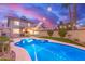 Inviting backyard oasis with a refreshing pool, lush greenery, and a cozy outdoor seating area at 4106 E Muirwood Dr, Phoenix, AZ 85048