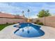 Inviting backyard with a sparkling pool, well-manicured lawn, and stylish exterior lighting at 4106 E Muirwood Dr, Phoenix, AZ 85048