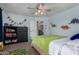 Light-filled bedroom featuring cheerful decor and a ceiling fan for added comfort at 424 W Midland Ln, Gilbert, AZ 85233