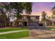 Charming two-story home with a well-manicured lawn and mature trees at 424 W Midland Ln, Gilbert, AZ 85233