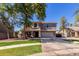 Charming two-story home features a well-manicured lawn and mature shade tree at 424 W Midland Ln, Gilbert, AZ 85233