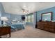 Spacious main bedroom with large windows, ceiling fan, and private ensuite bathroom at 424 W Midland Ln, Gilbert, AZ 85233
