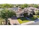 Stunning aerial view of a home with solar panels, tile roof, lush landscaping, and paved driveway at 5226 S Fairchild Ln, Chandler, AZ 85249
