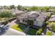 Upscale home showcasing stone accents, solar panels, a paver driveway, and landscaped front yard from above at 5226 S Fairchild Ln, Chandler, AZ 85249