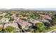 A bird's eye view of home and neighborhood with lush trees, sparkling pools, and mountain views at 5226 S Fairchild Ln, Chandler, AZ 85249
