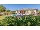 Expansive backyard with a pool, outdoor kitchen, and well-maintained lawn for outdoor enjoyment at 5226 S Fairchild Ln, Chandler, AZ 85249