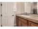 Bathroom featuring a decorative mirror, granite countertop, and wooden cabinets at 5226 S Fairchild Ln, Chandler, AZ 85249