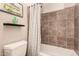 Bathroom showcasing a tiled shower, toilet, and artistic decor at 5226 S Fairchild Ln, Chandler, AZ 85249