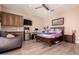 Bedroom with wood flooring, ceiling fan, workspace, wall cabinets, and queen-sized bed at 5226 S Fairchild Ln, Chandler, AZ 85249