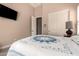 Comfortable bedroom featuring a TV and a bed with a stylish blue and white quilt at 5226 S Fairchild Ln, Chandler, AZ 85249