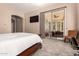 Bright bedroom featuring neutral tones, carpeted floors, and sliding glass doors to the outdoor space at 5226 S Fairchild Ln, Chandler, AZ 85249