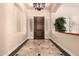 Inviting foyer with tile flooring, elegant lighting, and a decorative plant at 5226 S Fairchild Ln, Chandler, AZ 85249