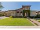Charming stone home with a well-manicured lawn, flower beds, and a brick walkway leading to the front door at 5226 S Fairchild Ln, Chandler, AZ 85249