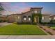 Charming stone home with a well-manicured lawn, flower beds, and a brick walkway leading to the front door at 5226 S Fairchild Ln, Chandler, AZ 85249