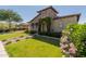Charming stone home with a well-manicured lawn, flower beds, and a brick walkway leading to the front door at 5226 S Fairchild Ln, Chandler, AZ 85249
