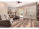 Open-concept living room with hardwood floors, fireplace, and access to the kitchen and backyard at 5226 S Fairchild Ln, Chandler, AZ 85249